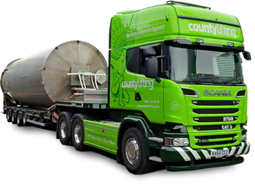 Green branded lorry carrying silo on trailer